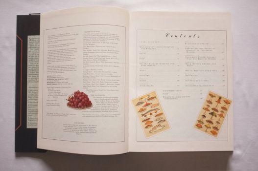 The double-page spread listing the Contents of The Shorter Mrs. Beeton is decorated in colour with red grapes, platters of sea food and an array of puddings and fruit. The 16 chapters run from Soups and Fish through to Bread, Biscuits and Cakes.