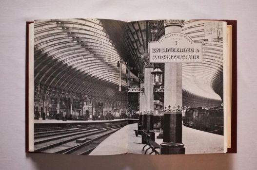 At the beginning of Chapter 3 of The Railways of Britain by Jack Simmons, on Engineering and Architecture, a double-page black-and-white photograph celebrates the dramatic vista of the curved iron roofs of York station in the days when wooden train carriages stood at the platforms. 