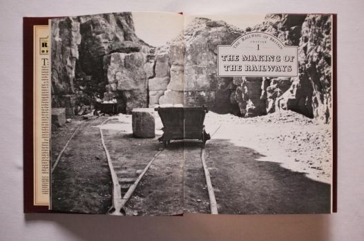 In this double-page black-and-white photograph on pages 8-9 of The Railways of Britain, taken in 1911, miners load a wagon at Lockhampton Hill Quarry near Cheltenham. 