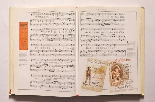 The music for The Lily of Laguna decorated with a poster and two song sheet covers.