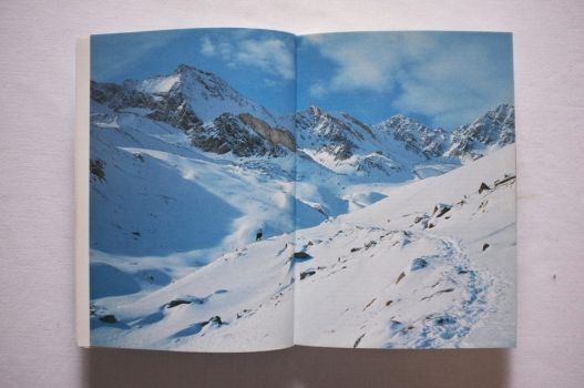 A double-page spread of a snowy Alpine hiking trail in the Valle d’Aosta. 
