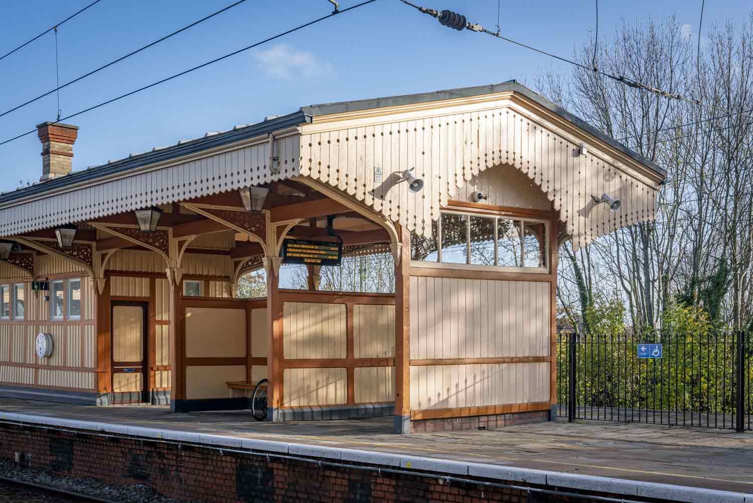 The wooden island platform building at Hanwell Station is painted brown and cream.