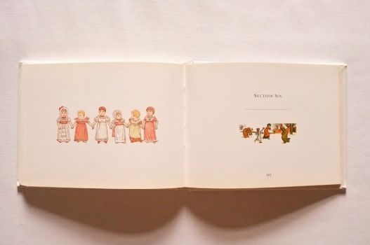 A row of toddlers holds hands, while a family have a snowball fight.