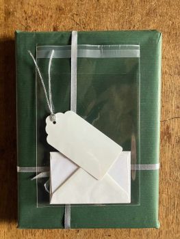 This colour photograph depicts the gift tag, envelope and card that come with free gift-wrapping.