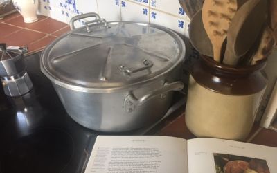 Photo of stewpan and recipe book.