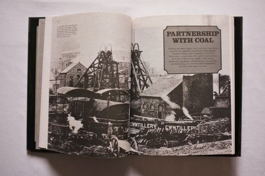 A picture essay on the Partnership with Coal opens with a double-page black-and-white photograph of the pithead at a South Wales colliery in about 1900, its winding gear driven by steam power supplied from two engine houses. 
