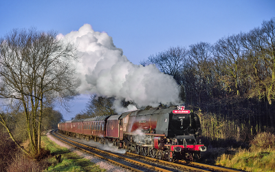 In this colour photograph by ©Dick Manton the 4-6-2 Coronation class locomotive Duchess of Hamilton hauls a special passenger train at Pontefract, West Yorkshire, smoke pouring from its chimney.