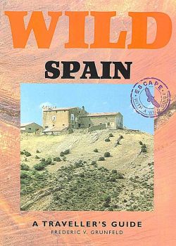 The terracotta Wild Spain cover features a traditional hilltop farmhouse.