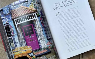 A double-page spread from ‘Doors of London’ features a full-page image of a colourful door and a column of text entitled Obsessed with Doors.