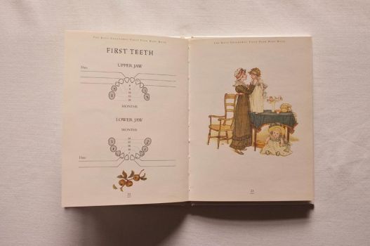 Pages 22 and 23 of The Kate Greenaway First Year Baby Book have a graphic to fill in with the dates that your child’s first teeth come through, with national averages for guidance, and a colour illustration of a mother consoling one of her children whilst the other mopes on the floor.