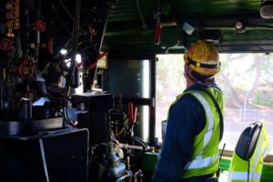 In this colour photograph taken on Ian Logan’s camera a crew member checks equipment above the engineer’s seat in the cab of Big Boy 4014.