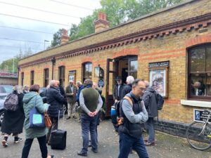 In the car park side Bricket Wood Station, members of the Railway Heritage Trust and the Bricket Wood Station Trust assemble for the unveiling of a commemorative plaque.