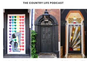 In this colour photograph are three doors. The first one has a white background with rainbow-coloured hearts and a girl in black and white doing yoga, with a daisy between her feet. The second one is a big black door with a fanlight and lantern and a small bush on the left side. The last one is a red, yellow and blue Art Deco door with stained glass sunburst motif with three stars