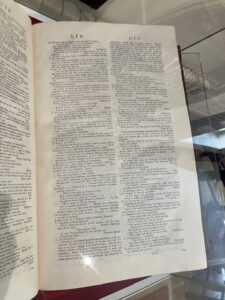 In this colour photograph taken in the library of Dr Johnson’s house, a volume of his ‘Dictionary of the English Language’ is displayed open at the page beginning with the entry for Libertine. 