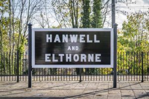 The black-and-white original sign for Hanwell station is large and boldly lettered.