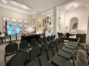 In this colour photograph, the lights are on, the seats laid out and the bar ready at the Authors’ Club for the evening talk on doors.