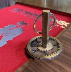 Colour photo of Super De Luxe Presentation Box open with close-up of brass hexagonal key in brass cog wheels of lock.