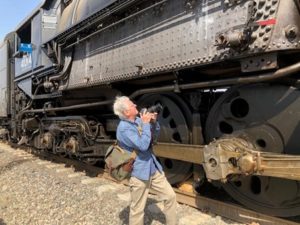 In this photograph taken in the West Colton Yard outside Los Angeles on 9th October 2019, Ian Logan peers up in astonishment at the Union Pacific steam locomotive Big Boy 4014. 