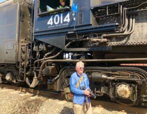 In this colour photograph the designer Ian Logan is dwarfed by the Union Pacific locomotive Big Boy 4014.