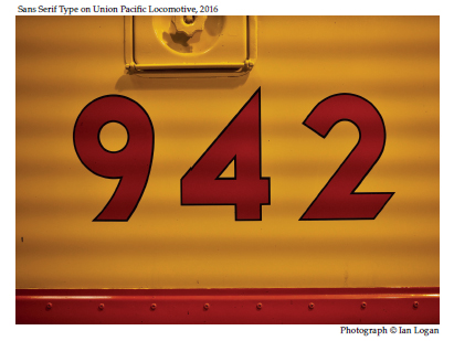 In this colour photograph taken by the railfan designer Ian Logan, the number 942 is painted in red with a fine black border in a bold sans serif type on the rich Armour Yellow bodywork of a Union Pacific locomotive.