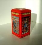 Colour photograph of a red British telephone box designed by Ian Logan with an illustration by Adrian Chesterman which shows a man talking on one elevation and a woman on another.