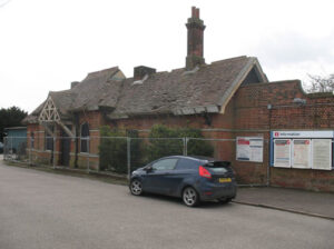 Trimley Station lies derelict behind fencing.