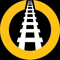 The We Are Railfans logo is a railway track printed white on black within an ochre circle. 