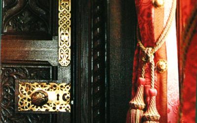 Colour photograph of richly patterned and tasselled red curtains in the Speaker's House at the Palace of Westminster.
