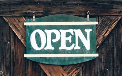 Colour photograph of an ‘Open’ sign. If you have time to read, we can send you a book.
