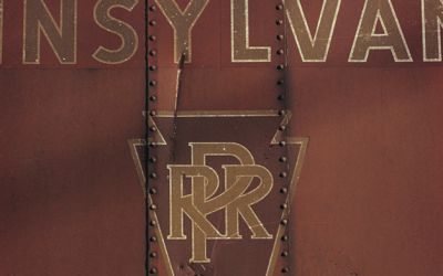 In a colour photograph taken by Ian Logan in the 1970s, the keystone logo of the Pennsylvania Railroad survives on the side of a freight wagon years after the company ceased to exist.