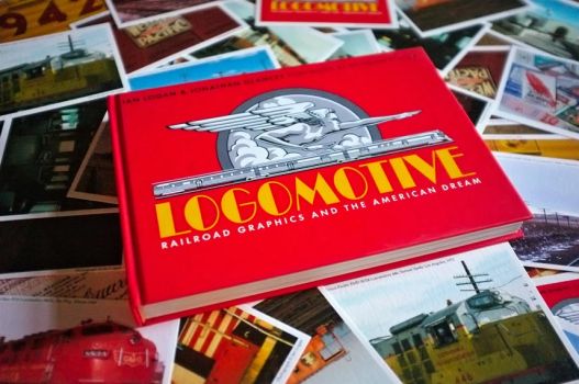 Ian Logan’s book Logomotive lies on an array of postcards created from period photographs and ephemera.