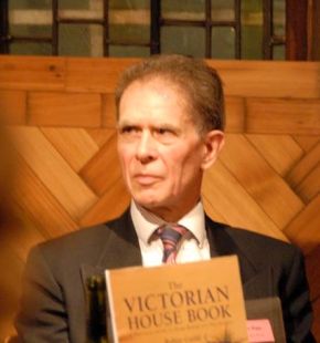 Colour photograph of Simon Rigge holding 'The Victorian House Book' at the launch of the 4th Edition.